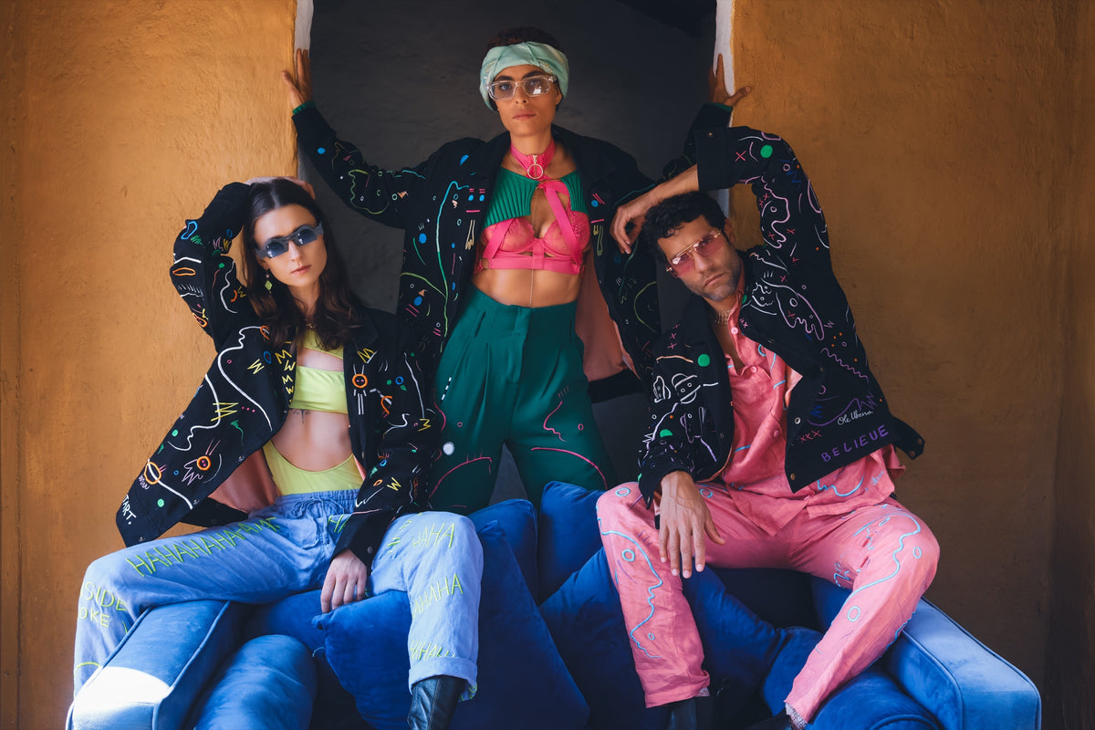 Three people wearing UKENA wearable artworks