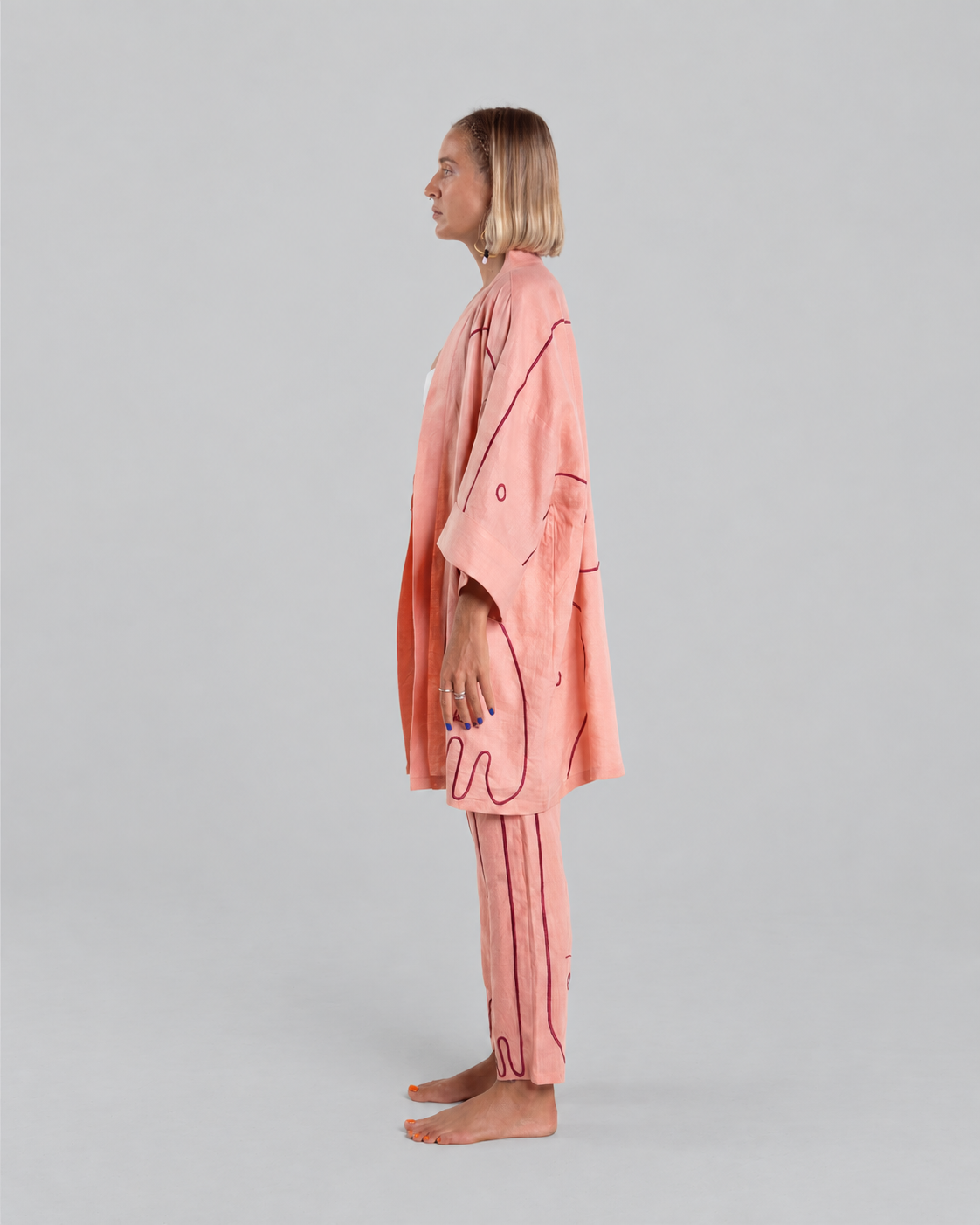 Peachy Punk Giraffe kimono set, side view against a neutral grey background