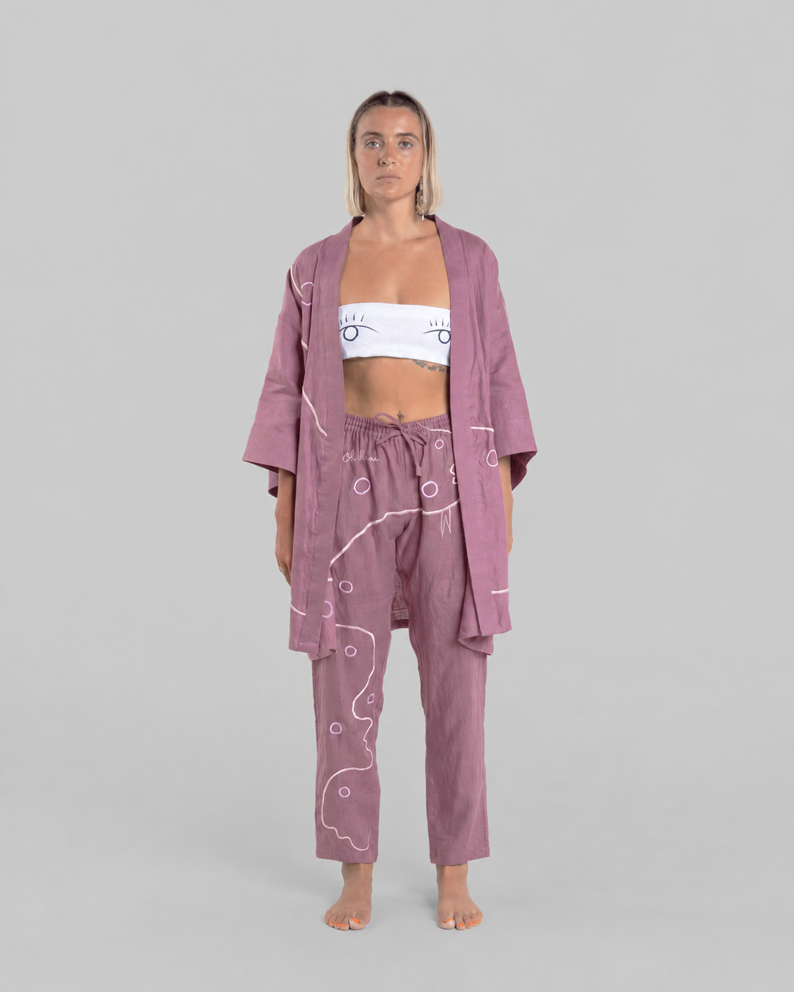 Purple Vortex kimono set, front view on a model against a neutral grey background