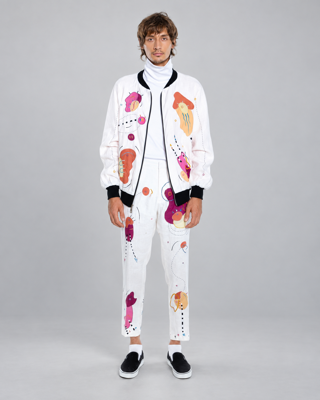 White Lies, Bright Linen bomber jacket worn by a model, front view against a neutral grey background