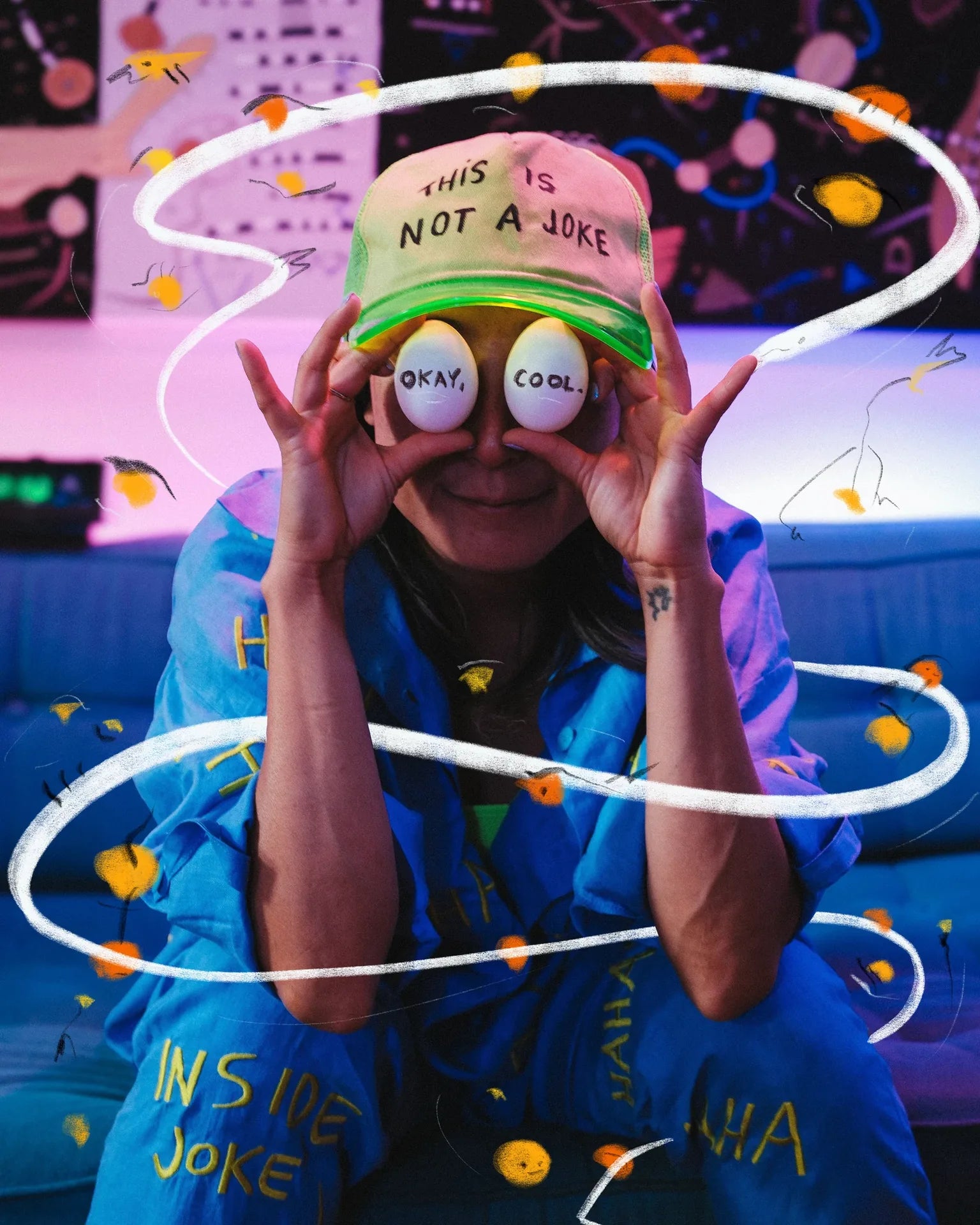KOTOE in blue UKENA linen, holding two balls over her eyes amid drawn lines