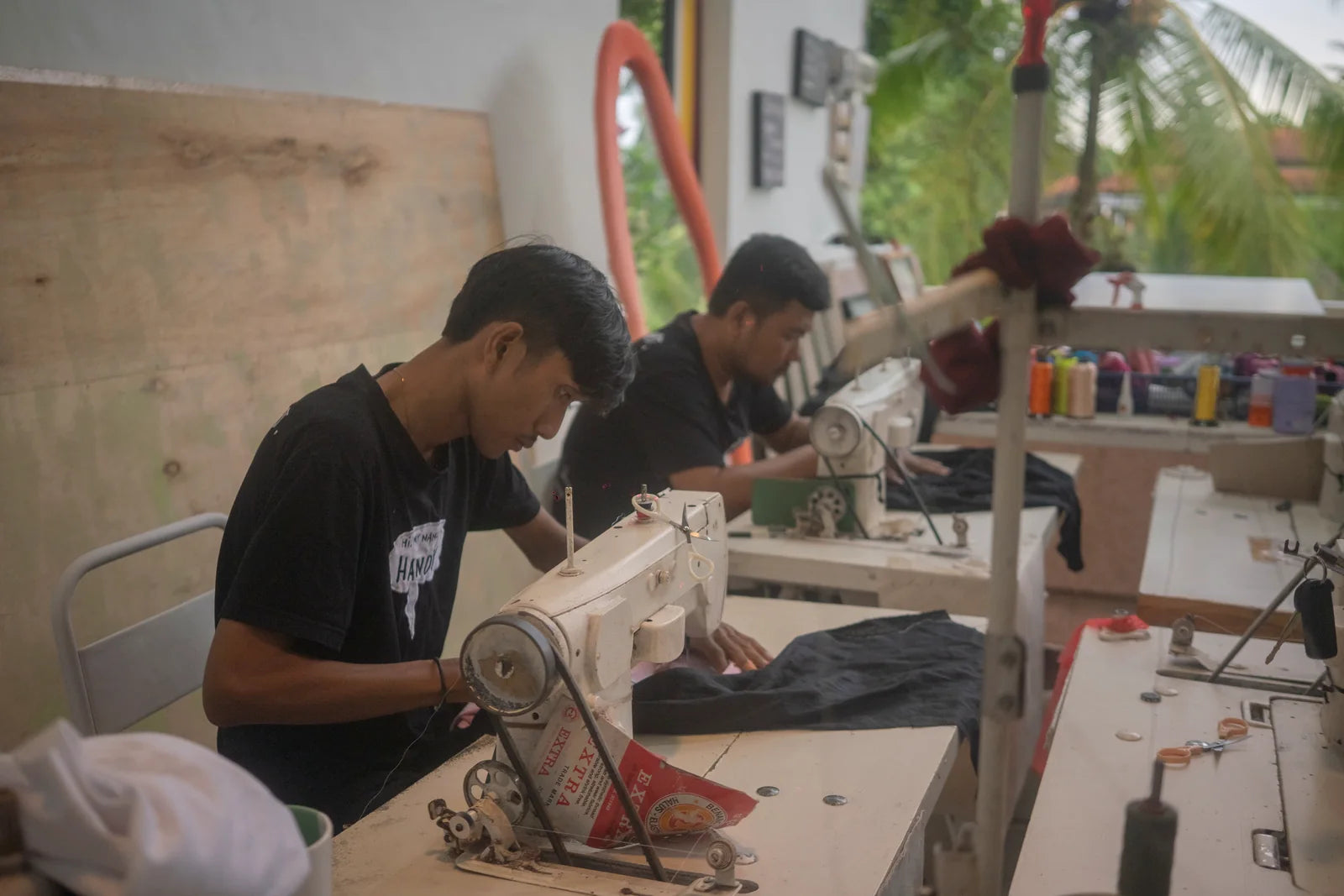 The AIR studio team guiding embroidery at the working table