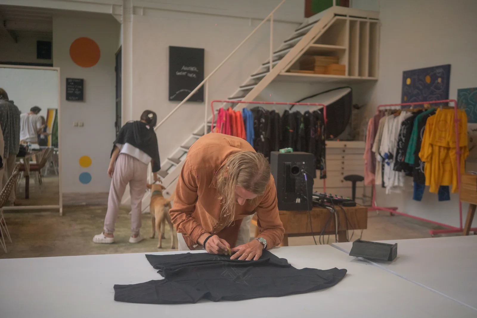 A participant drawing directly onto a black garment
