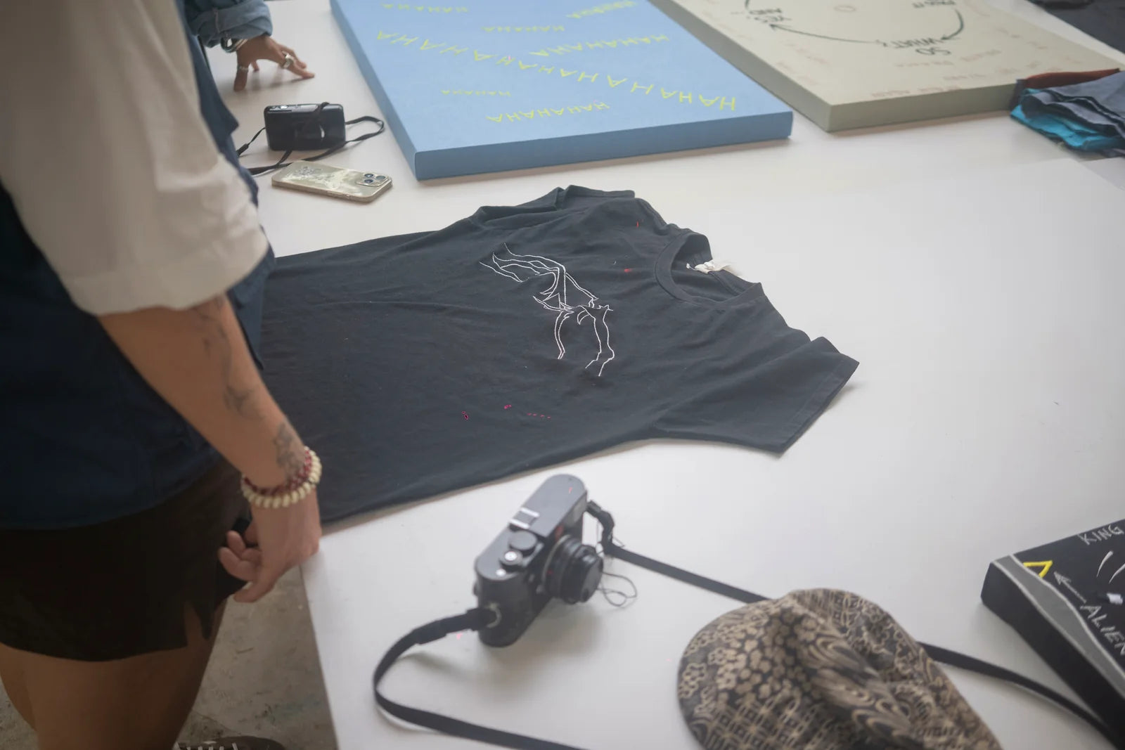 A black garment with a new white drawing laid on the table