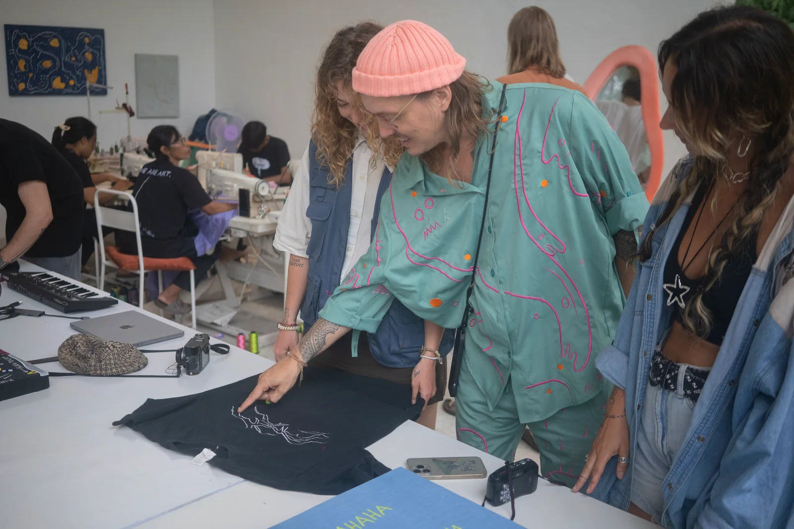 Ole and participants working around a black garment