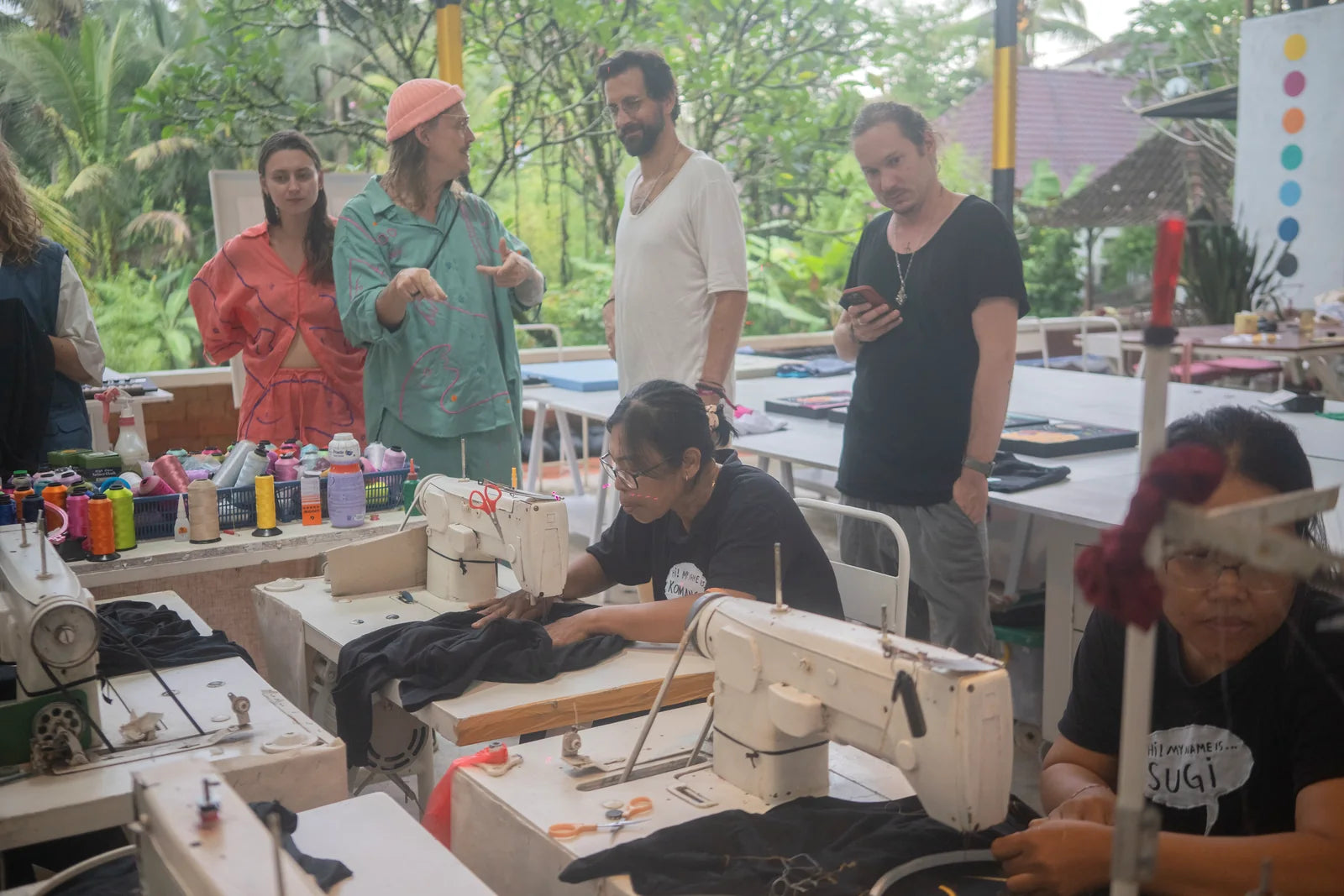 The AIR team embroidering drawings while guests gather