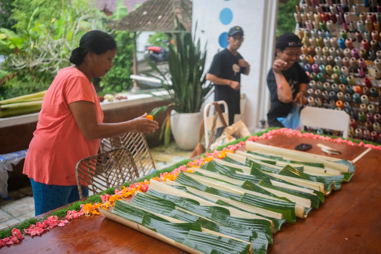 Food being arranged on banana leaves for the shared table