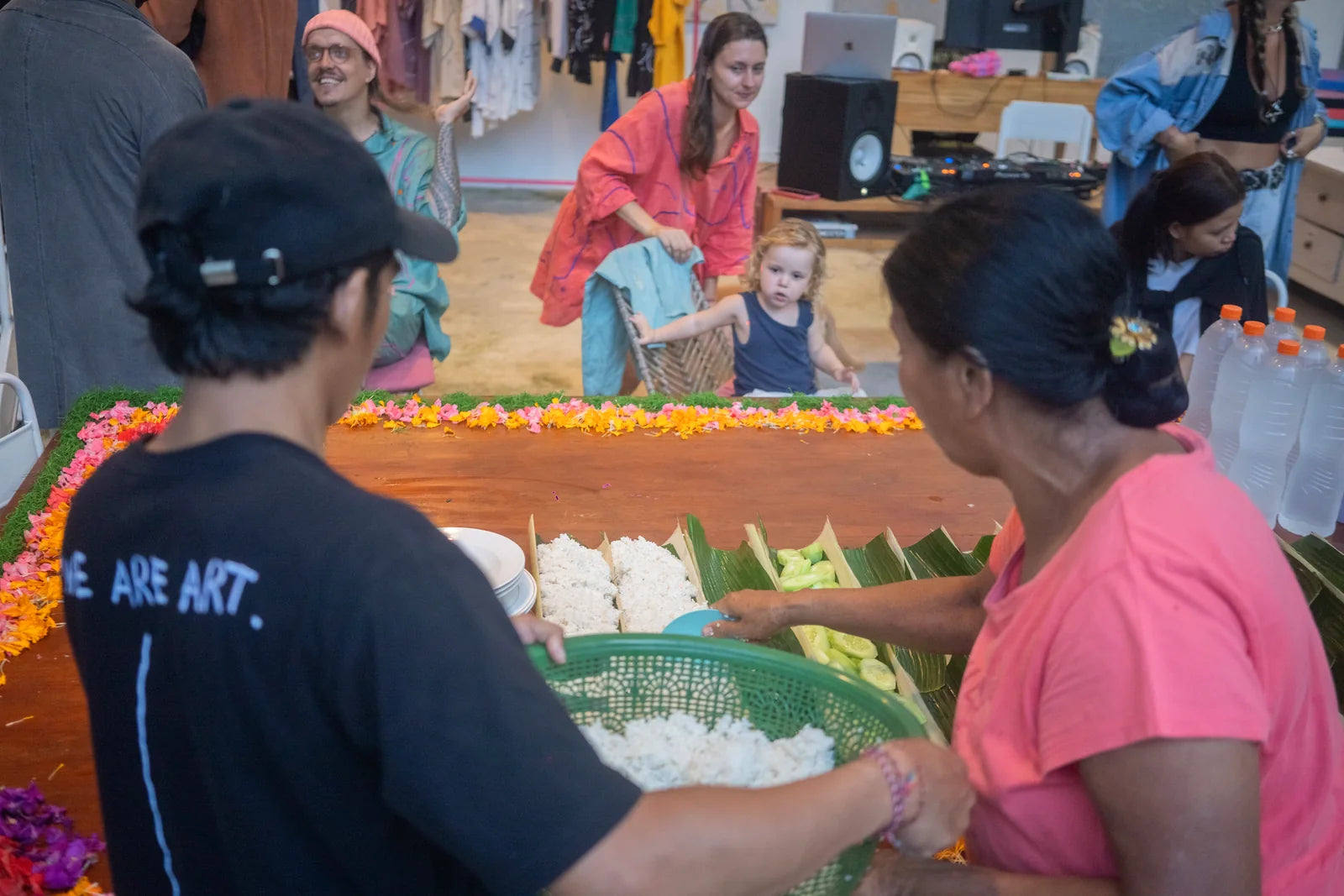 The shared table being assembled with flowers and food