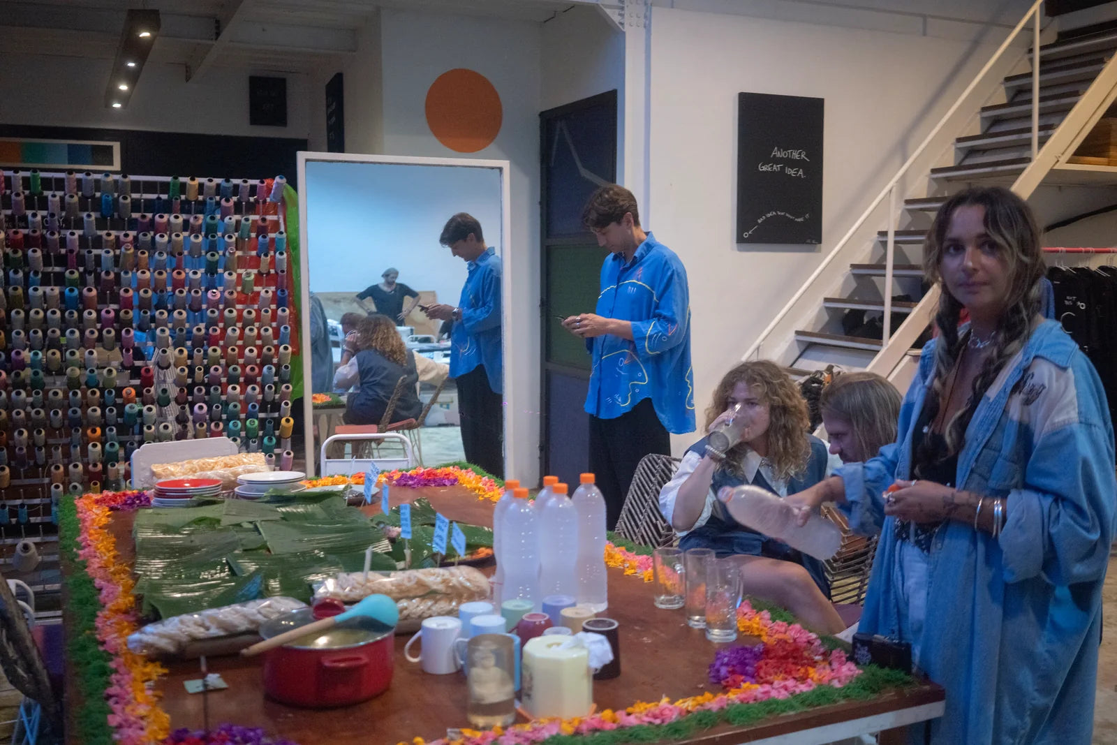 Guests gathering around the long shared table