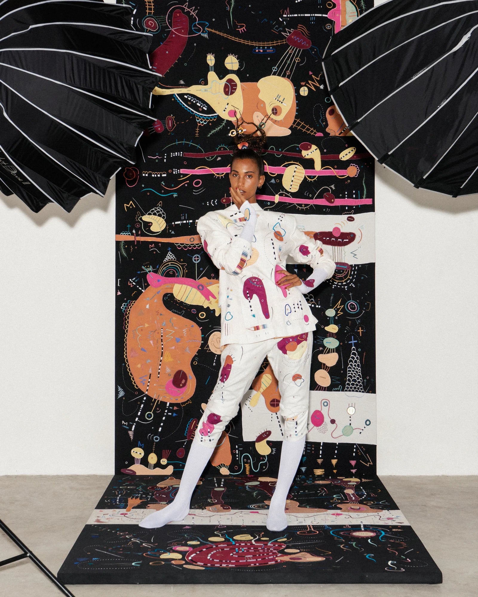 The photographic lights remain visible around a white Antidote suit