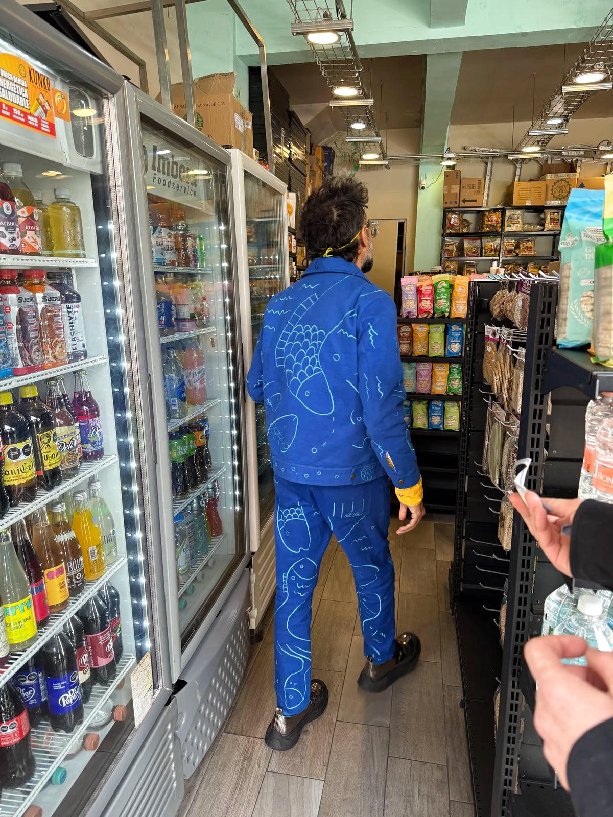 Varun and Morta walking through a neighbourhood shop