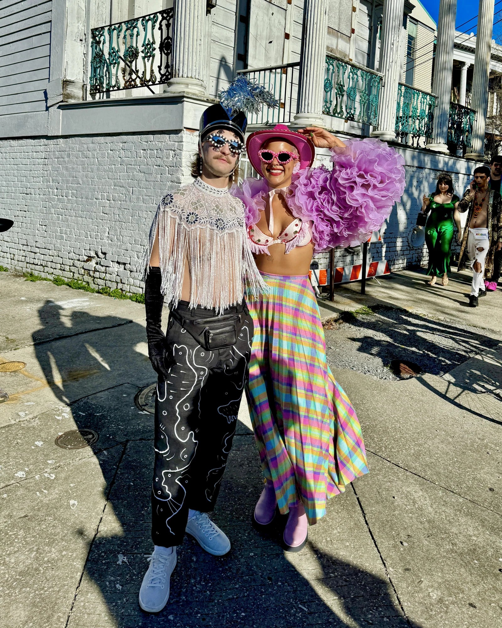 Forrest and Michelle outdoors in colourful outfits, with the embroidered trousers worn again
