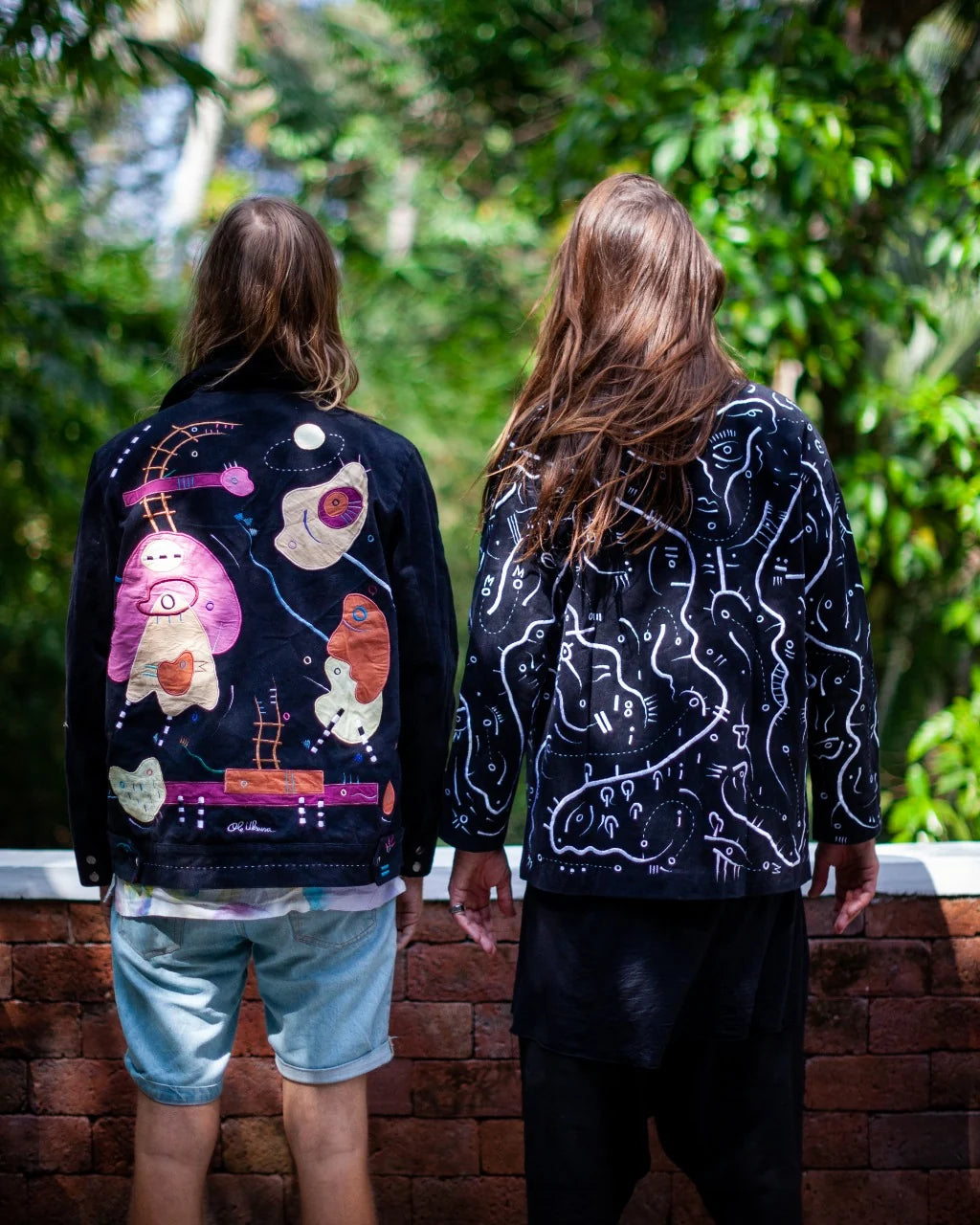The backs of two related UKENA jackets worn by Ole and Jessey