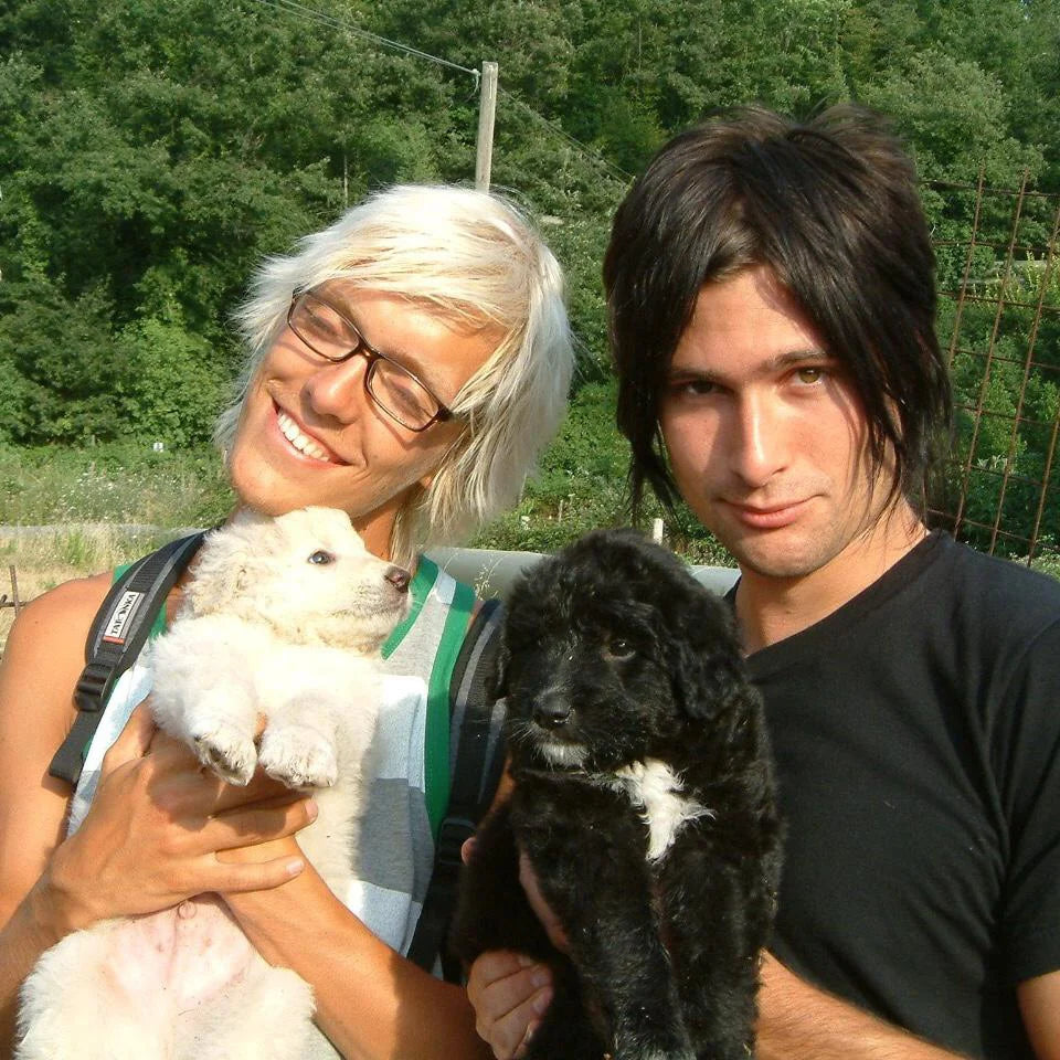 A young Ole and Jessey Cinis holding two small dogs