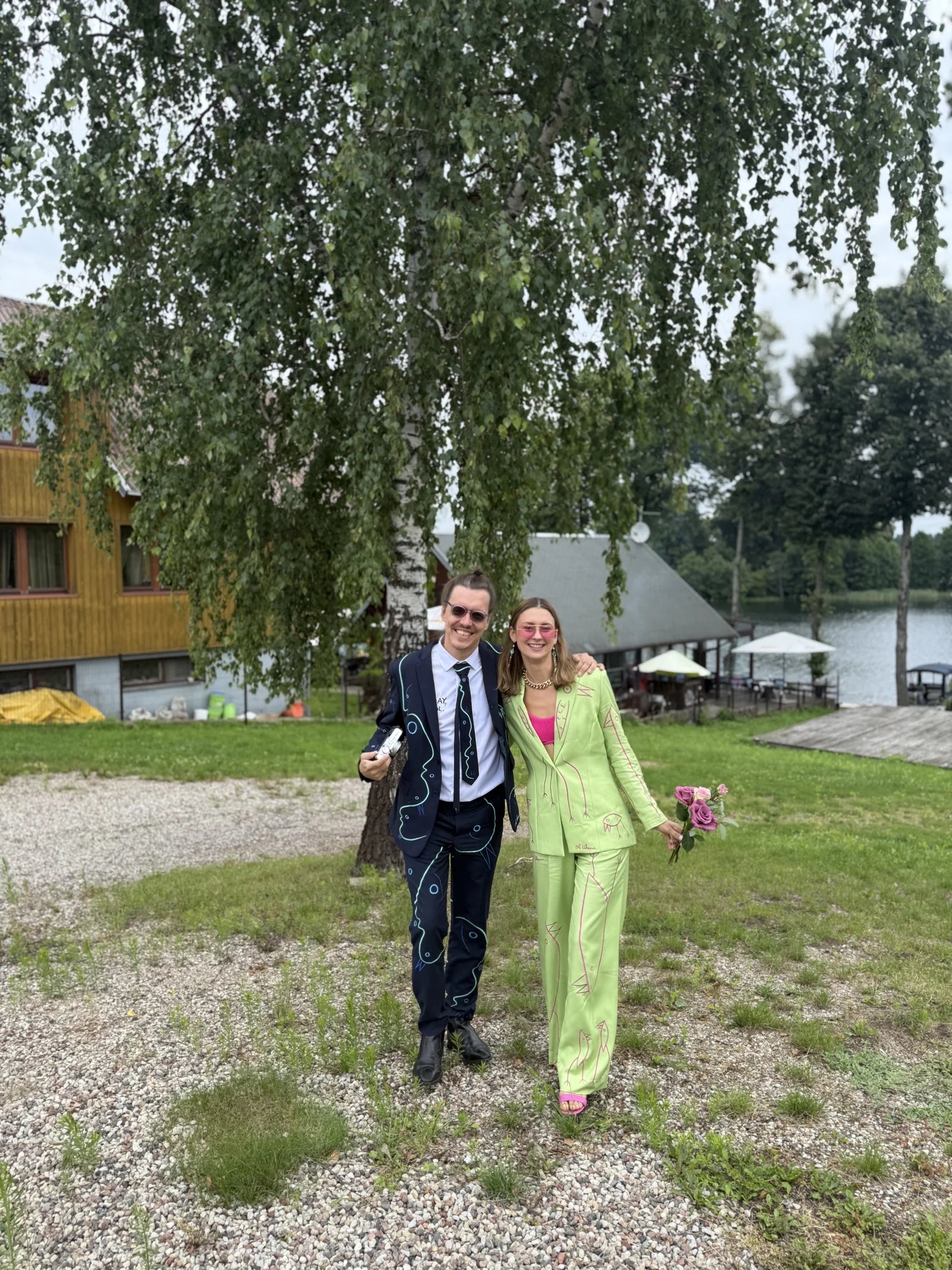 Ole and Morta standing together in navy and green custom UKENA suits
