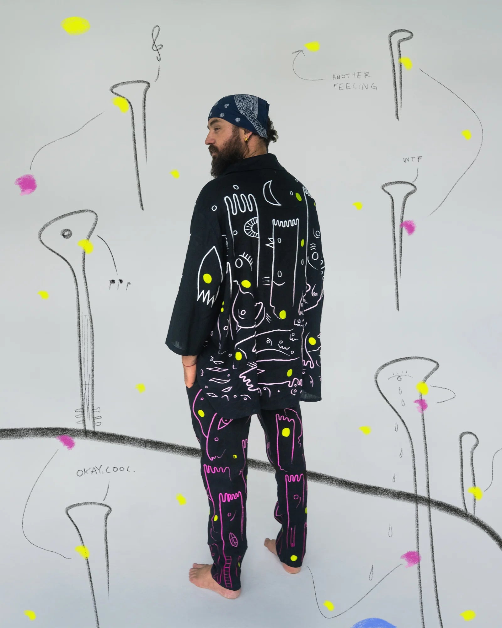 The back of RY X in the embroidered work, with drawn lines continuing into the image