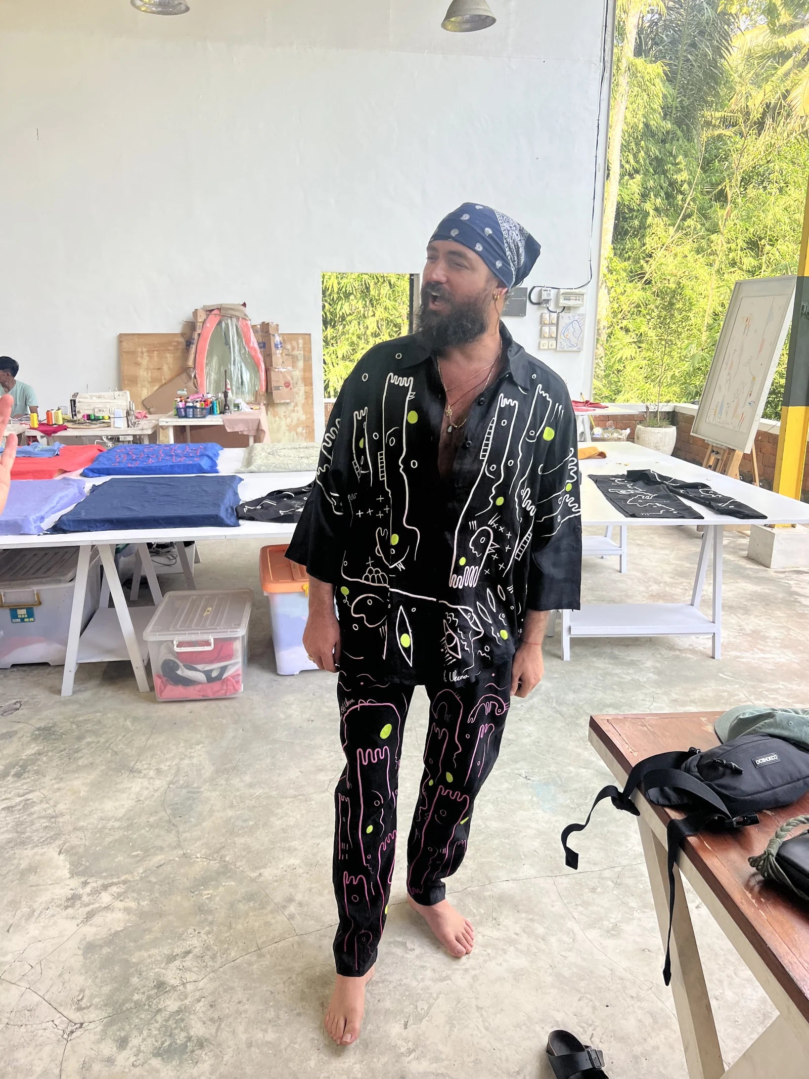 RY X trying on a black embroidered linen set in the studio